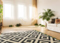 Clean living room, with a clean carpet and geometric rug.