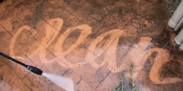 jet washing a dirty patio