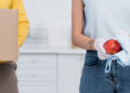 A tenant cleaning a kitchen and bathroom thoroughly before moving out, with cleaning supplies and cloths visible, preparing the property for handover.