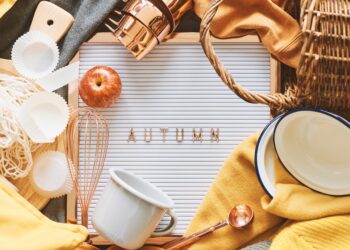A neatly organised loft storage area with labelled boxes, folded clothes, and seasonal items arranged, representing the Autumn Declutter Challenge.