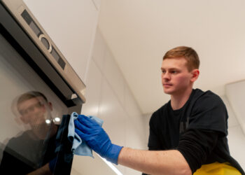Professional oven cleaning showing a spotless oven interior with racks removed and grease-free surfaces