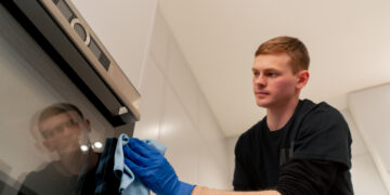 Professional oven cleaning showing a spotless oven interior with racks removed and grease-free surfaces