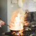 Grease buildup on a kitchen hob and splashback during winter cooking, showing stubborn residue that is harder to remove in colder temperatures.
