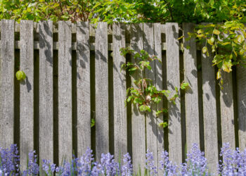 Metal garden fence panels installed along a residential boundary in a UK garden