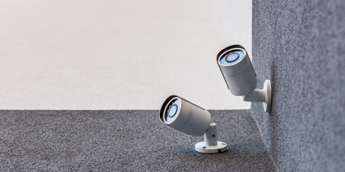 Smart home security camera monitoring a house exterior as part of a modern home security system