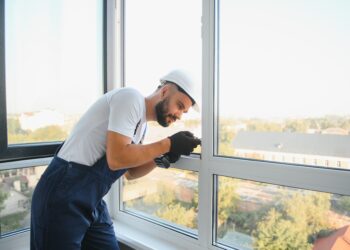 Damaged double-glazed window with visible condensation between panes and worn window frame
