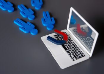 Magnet attracting blue customer icons from a laptop, symbolising a managed referral service connecting homeowners with trusted tradespeople.