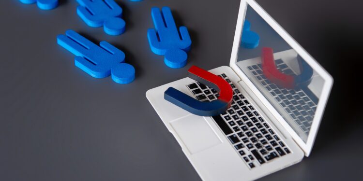 Magnet attracting blue customer icons from a laptop, symbolising a managed referral service connecting homeowners with trusted tradespeople.