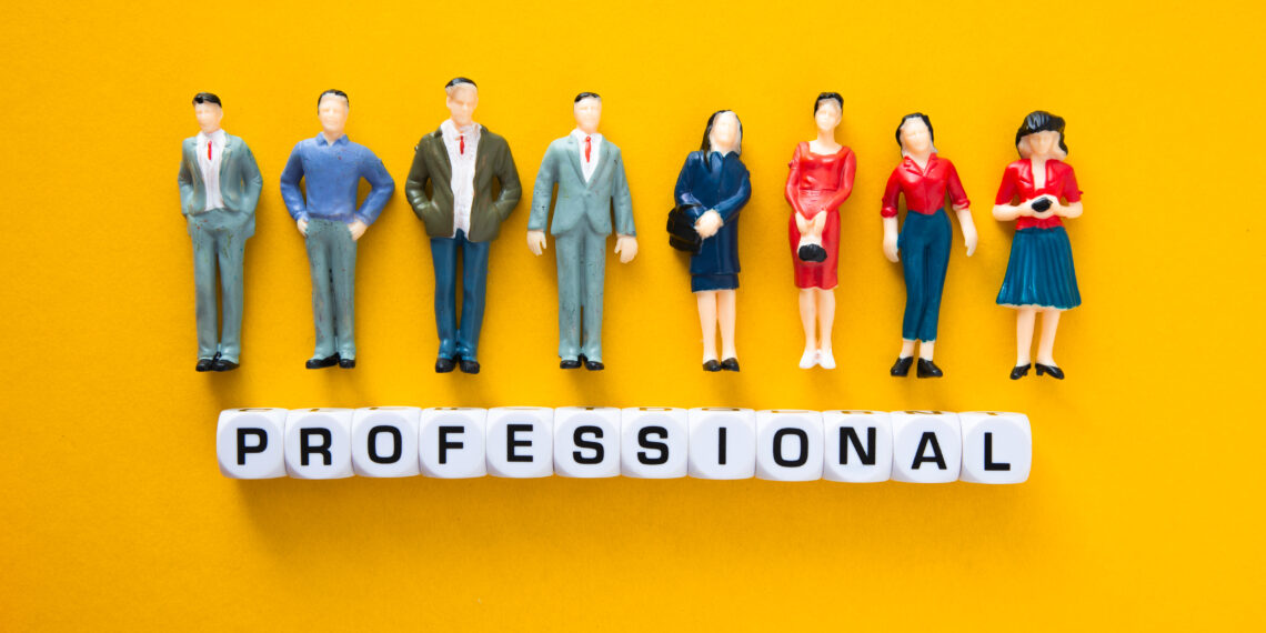 Miniature figures representing vetted professionals standing above letter blocks spelling “professional”, symbolising the process of vetting local professionals and background checks for trades in the UK.