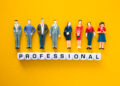 Miniature figures representing vetted professionals standing above letter blocks spelling “professional”, symbolising the process of vetting local professionals and background checks for trades in the UK.