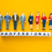 Miniature figures representing vetted professionals standing above letter blocks spelling “professional”, symbolising the process of vetting local professionals and background checks for trades in the UK.