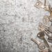Collection of assorted old metal keys scattered on a textured surface, symbolising outdated or multiple key access