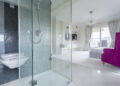 Contemporary wet room style bathroom with modern tiling, sleek fixtures, and homeowners comparing bathroom renovation and design options.