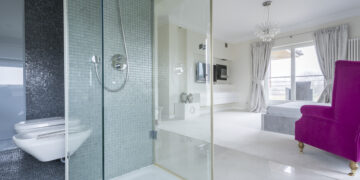 Contemporary wet room style bathroom with modern tiling, sleek fixtures, and homeowners comparing bathroom renovation and design options.