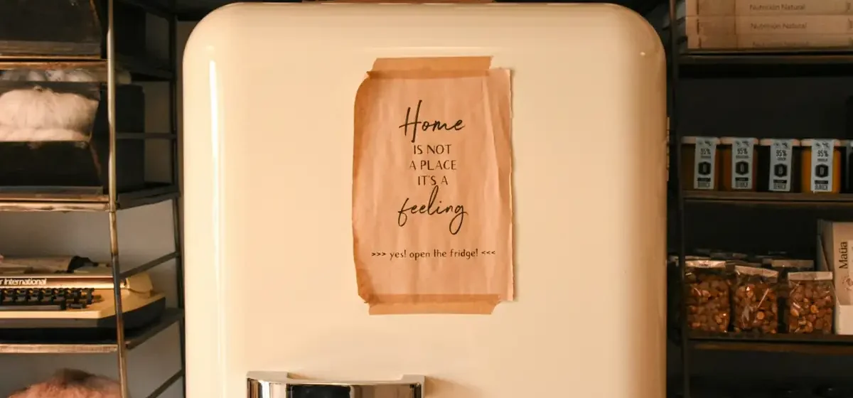 Freestanding refrigerator in a warmly lit domestic kitchen