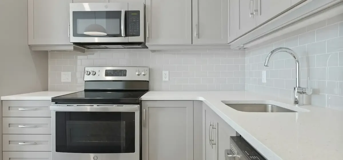 White microwave oven on a white kitchen cabinet