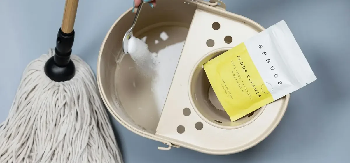 Cleaning powder being added to a mop bucket of water