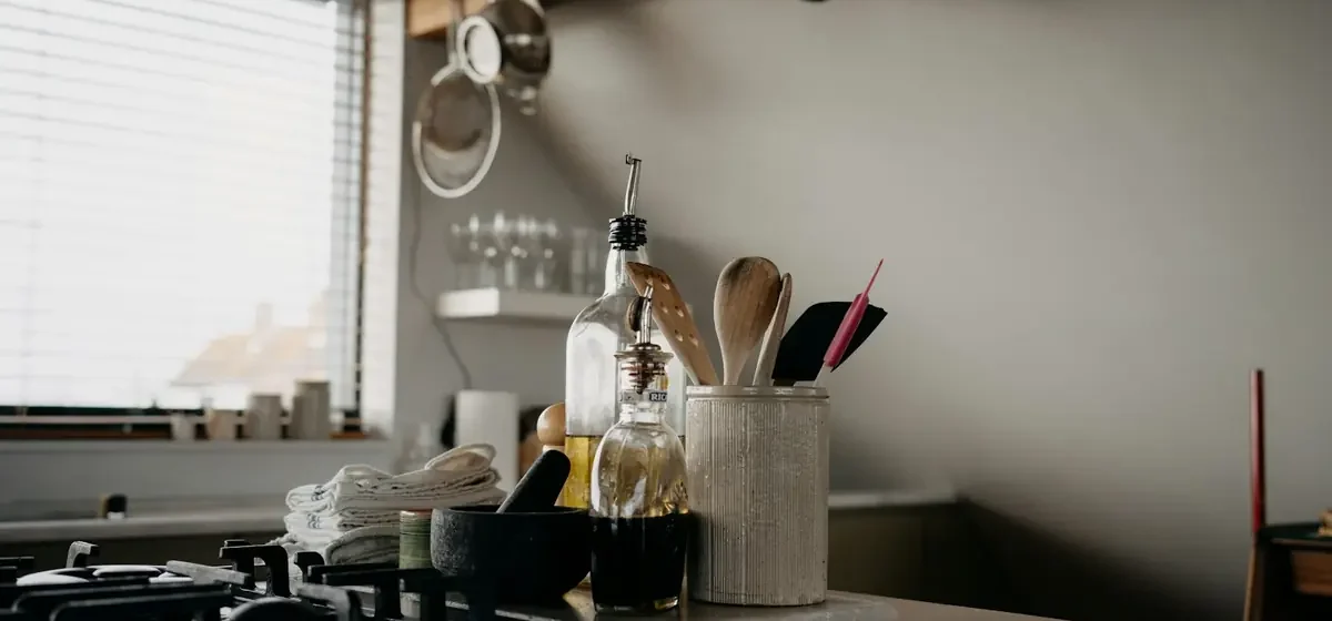 Tidy kitchen counter with utensils and bottles