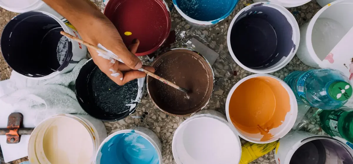 Row of open paint pots in many different colours