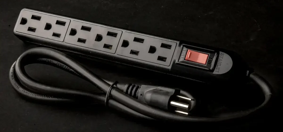 Black four-way extension lead with coiled cable and switch