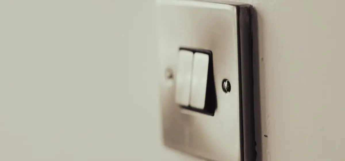 White twin light switch on a painted interior wall