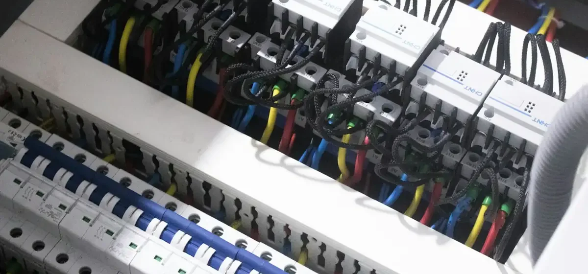 Circuit breakers and coloured wiring inside an open consumer unit