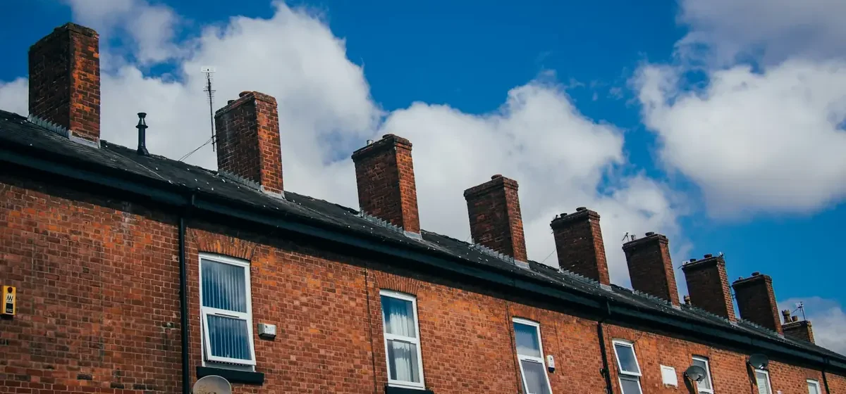 Row of red brick terraced houses on a quiet street