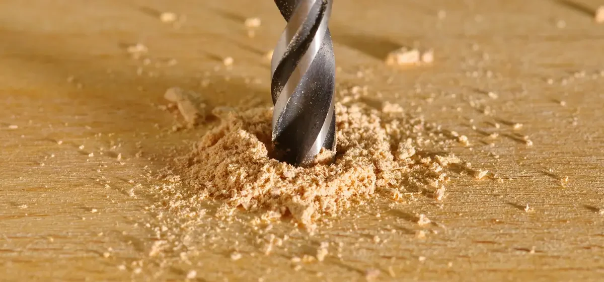 Power drill boring a hole into a piece of timber