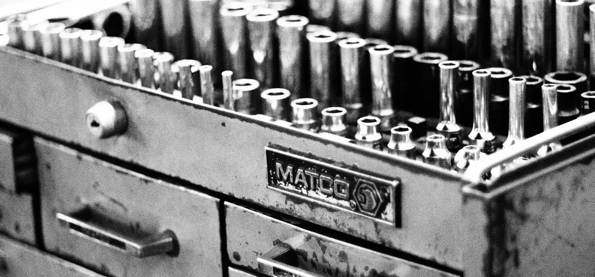 Open metal toolbox holding screws and small fixings