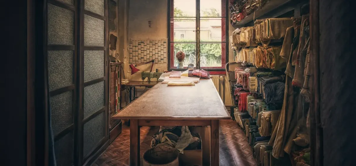 Old workshop with wooden bench and shelves full of stored items