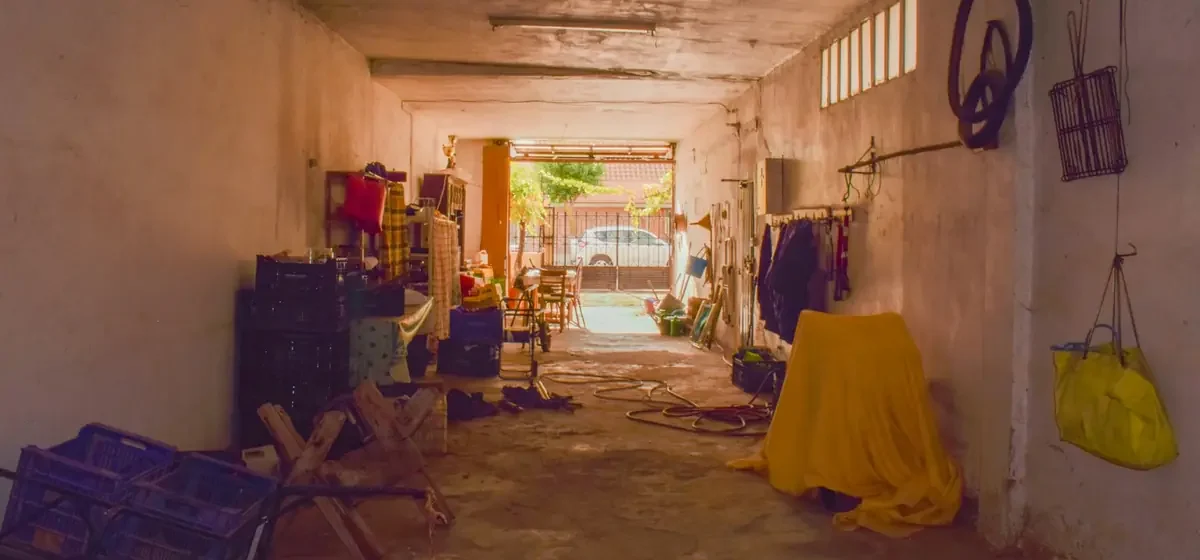 Garage interior holding stacked furniture and household items
