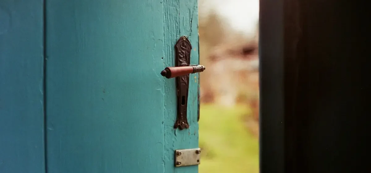 Blue painted wooden front door with metal lock and handle
