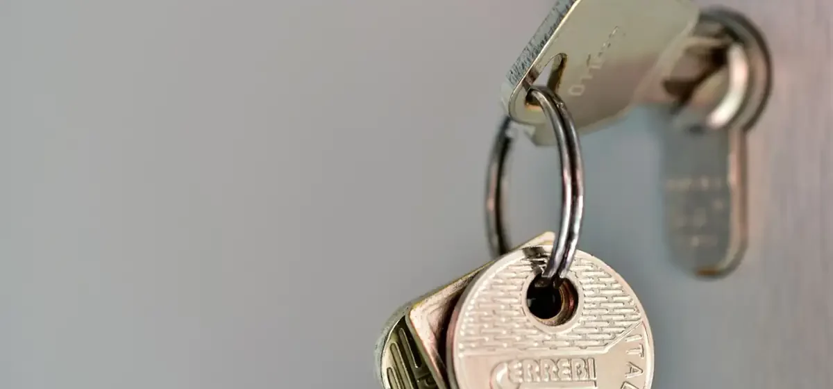 Bunch of door keys hanging on a metal hook