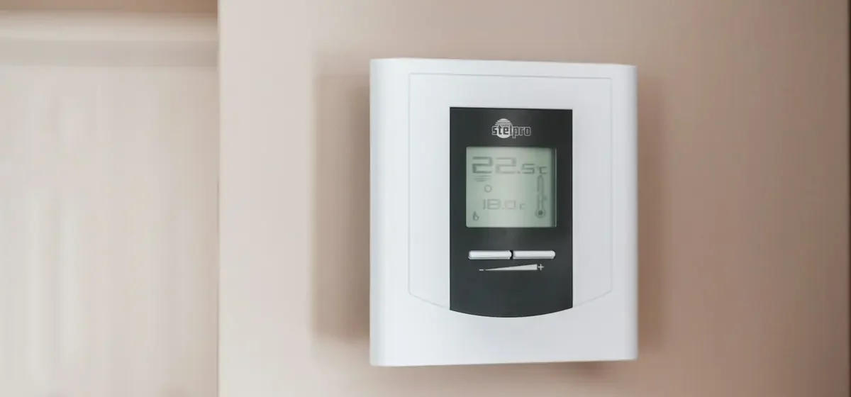 Wall thermostat dial showing a room temperature setting